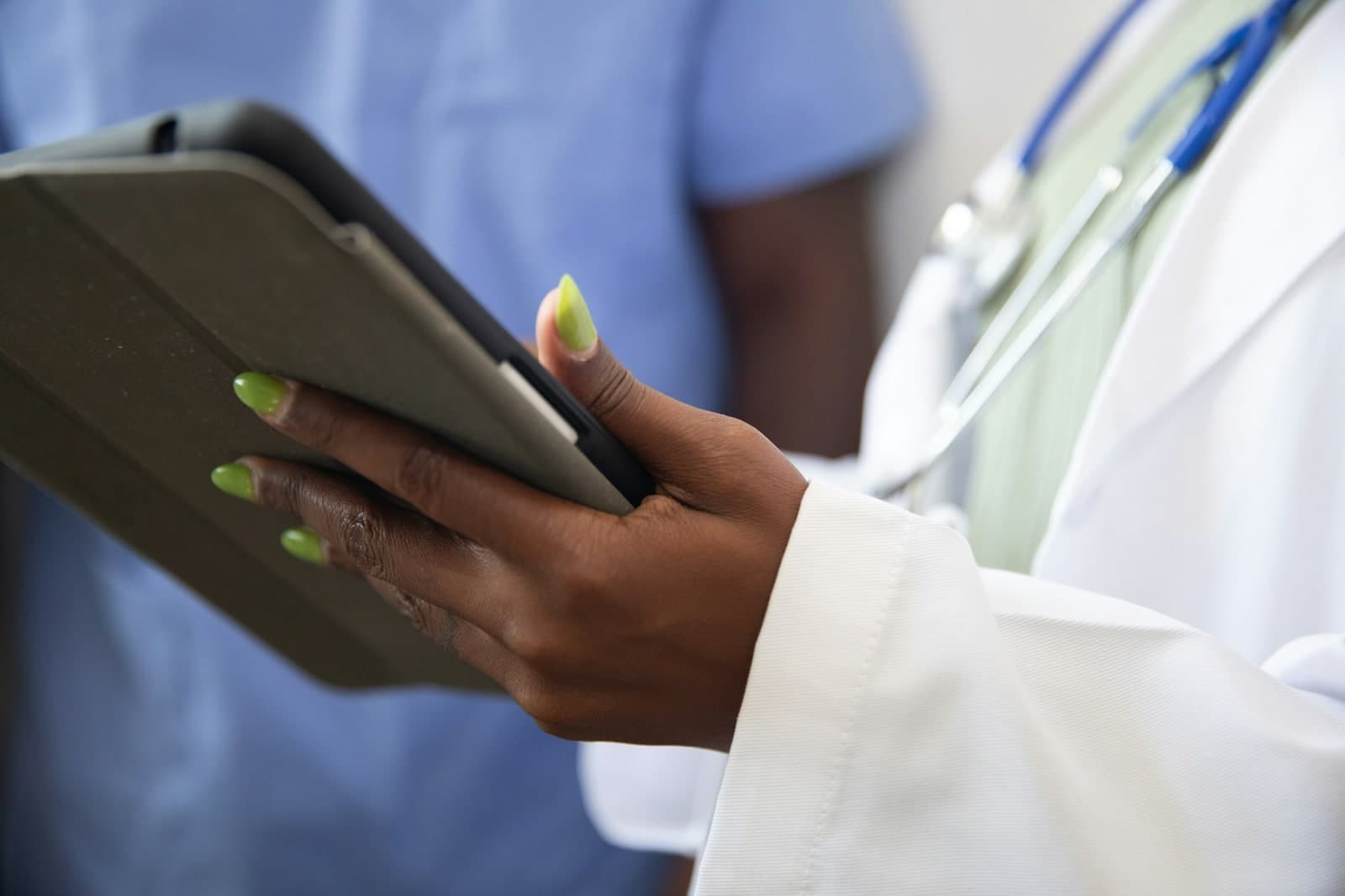 Healthcare professional using a tablet for digital health decision-making.