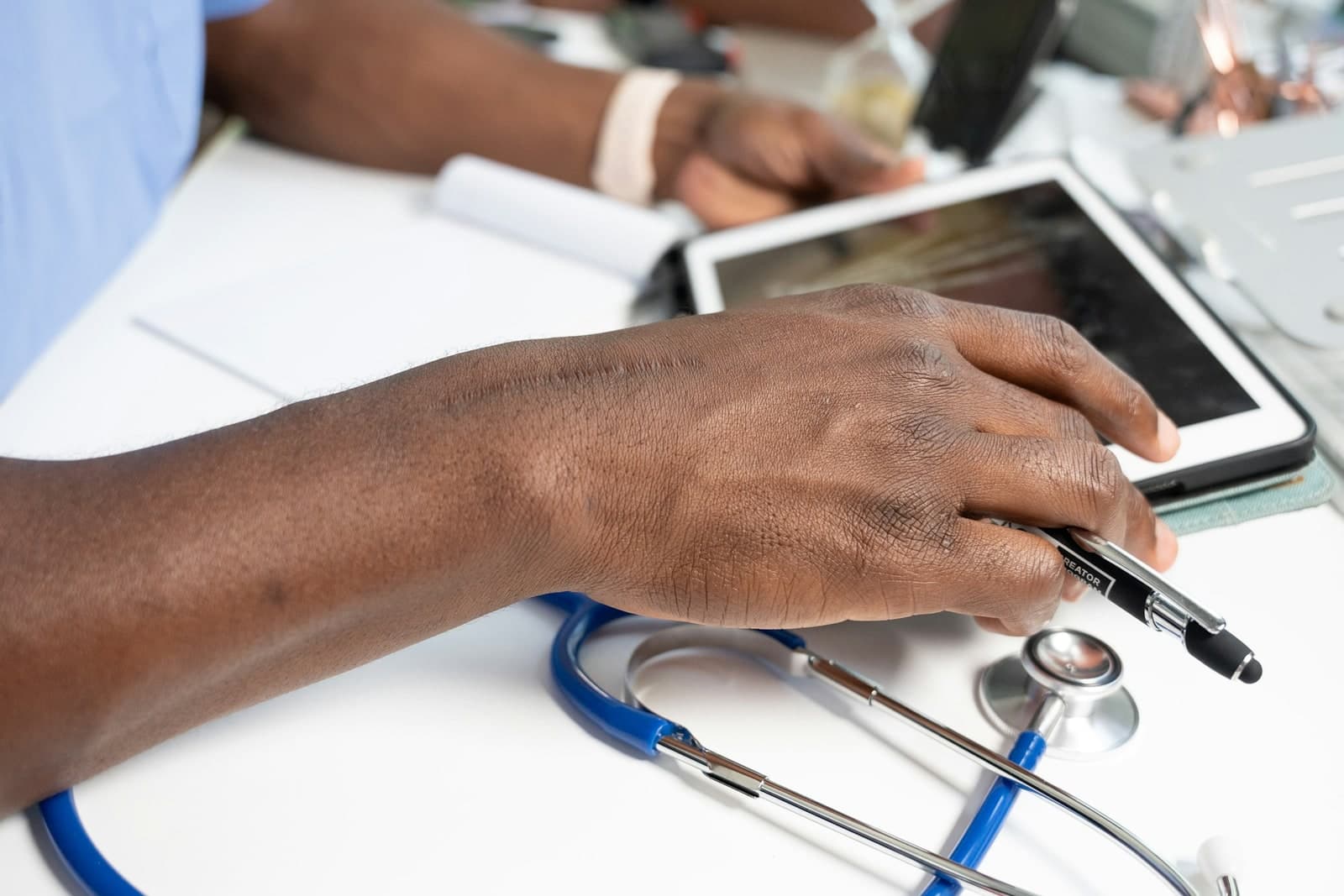 Hands working at a laptop, representing documented operating controls and assurance systems.