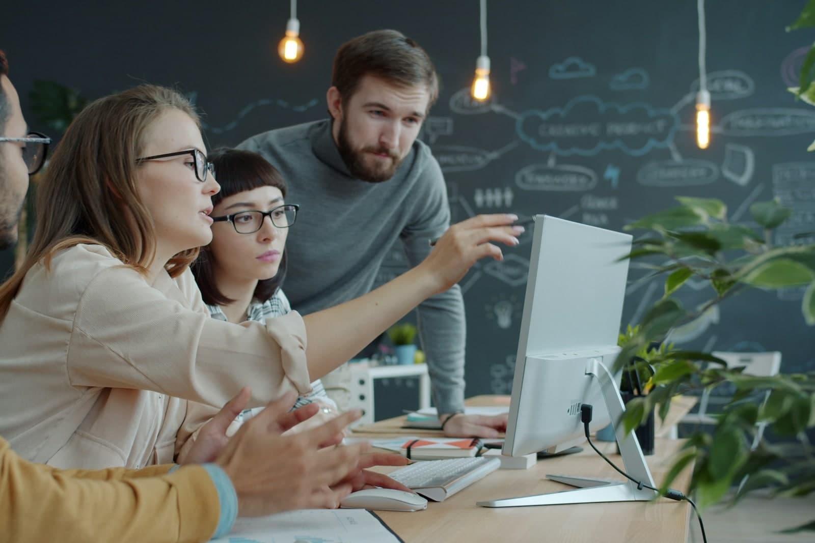 Team collaborating around a computer in a strategy session.